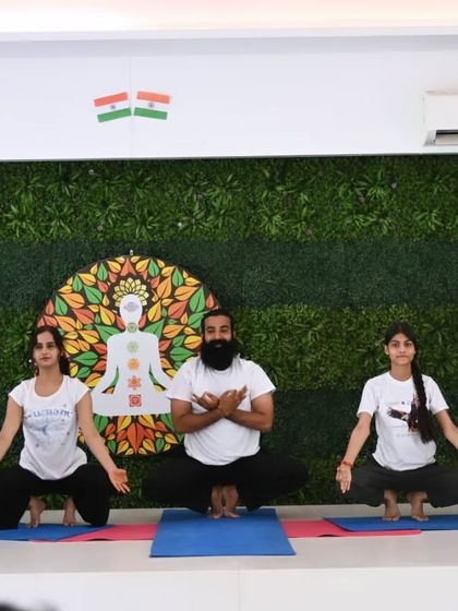 Our founder and instructors lead a group in Malasana (Garland Pose) during a yoga demonstration. We love sharing our practice and working together as a team to inspire our community.