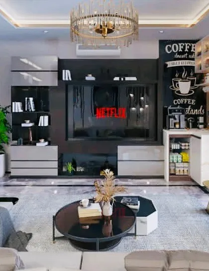 This living room is designed for comfort and sophistication, featuring a large entertainment unit with an integrated coffee bar. The design combines open shelving for display and closed cabinets for storage, perfect for modern living.
