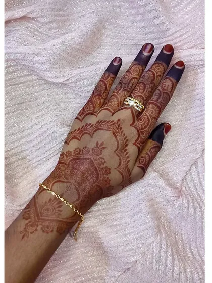 This design features a heart-shaped mandala, and the stain has come out beautifully rich and dark, especially on the fingers.