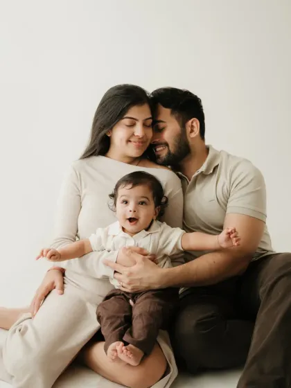 A joyful family photo with the baby making an excited expression. Capturing these spontaneous moments is the goal of a lifestyle family photographer.