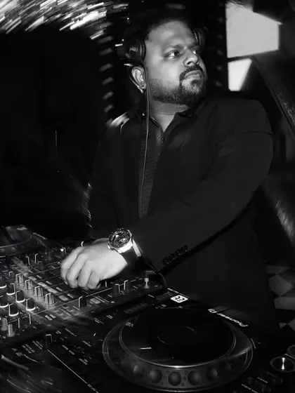 A black and white shot of me at the decks during a wedding party. The focus is always on the craft, carefully curating the sound for the night.