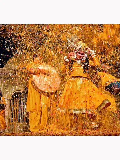 The explosive joy of Holi celebrations captured in a shower of golden petals. This photograph is about the energy and chaos of the moment, a vibrant cultural scene frozen in time. It is a testament to the power of color in documentary storytelling.