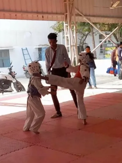 Two young fighters in the heat of competition. This image shows the focus and early development of skills in our junior athletes.