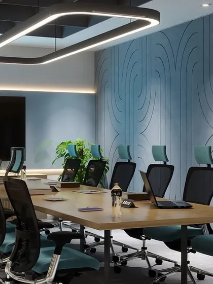 A closer look at the boardroom's textured wall, which adds depth and acoustic value. The modern chairs with teal upholstery provide a pop of color against the neutral conference table.