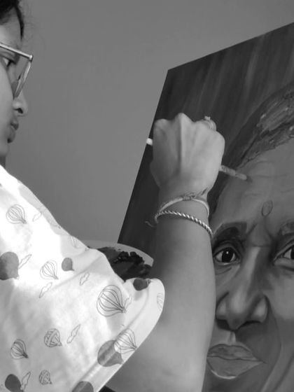 A black and white photo of me working on the same portrait, capturing the intensity and concentration that goes into my art.