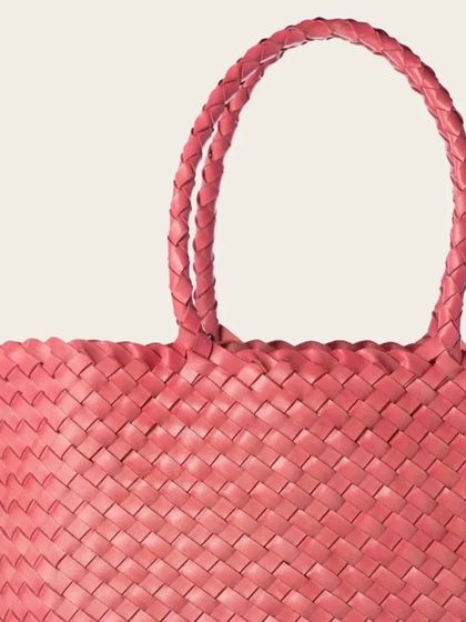 A close-up of the Axel Large Tote in Blush Pink, highlighting the intricate handwoven texture and the beautifully braided handles.