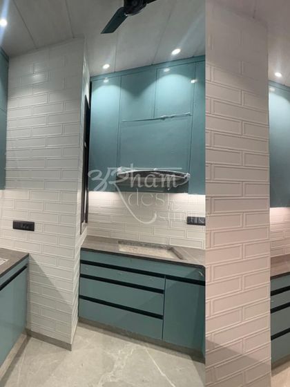 This angle highlights the textured white brick-patterned tiles and the sleek, handleless design of the lower cabinets. We focus on creating clean lines and practical surfaces in our kitchen interior designs.