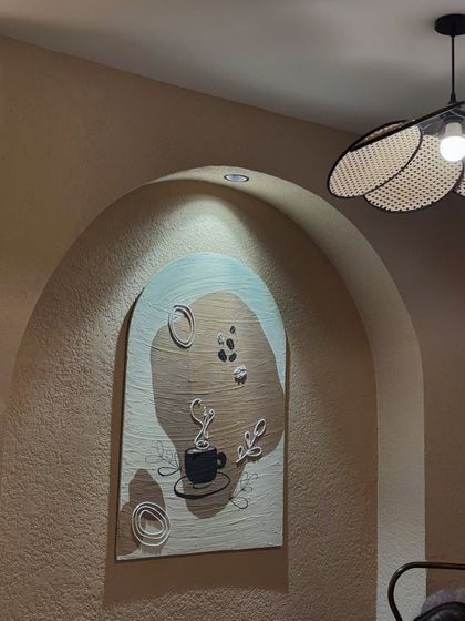 Another arched panel for the same cafe, this one with a coffee theme. It combines painting with 3D elements like a sculpted coffee cup and beans.
