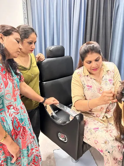 A photo from one of our exclusive hair extension training courses. I am showing students the proper technique for applying extensions, helping them grow their hairstyling careers.