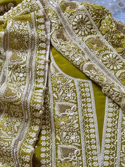 A close-up of our mustard green Chikankari ensemble, showcasing the heavy, multi-technique embroidery on the yoke. This piece combines threadwork with zero-sized embellishments for a subtle sparkle.