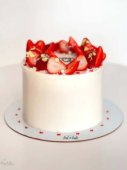 A seasonal favorite, this Vanilla Strawberry cake is topped with fresh strawberries, edible gold leaf, and tiny sugar pearls. It's available as a celebration cake or a smaller bento cake.