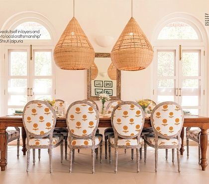 The dining room of the Loto Bianco villa featured in a design publication, with a quote about the villa revealing itself in layers and paying ode to local craftsmanship.