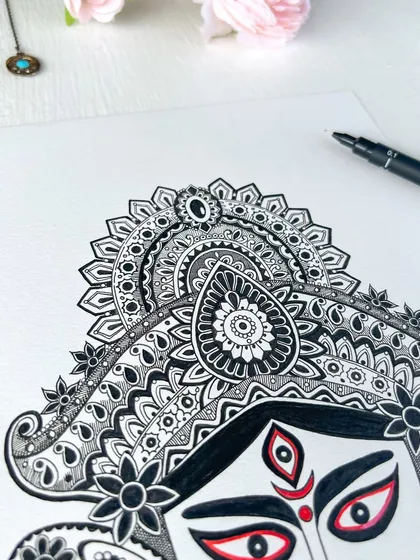 Another detail shot of the Durga artwork, showcasing the intricate patterns and paisley designs that make up her elaborate headdress.