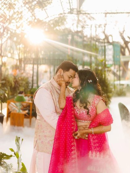 An intimate moment between the couple during their Mehendi. Abhishek's pastel pink kurta and bandi by Raghavendra Rathore coordinate perfectly with Shree's lehenga.