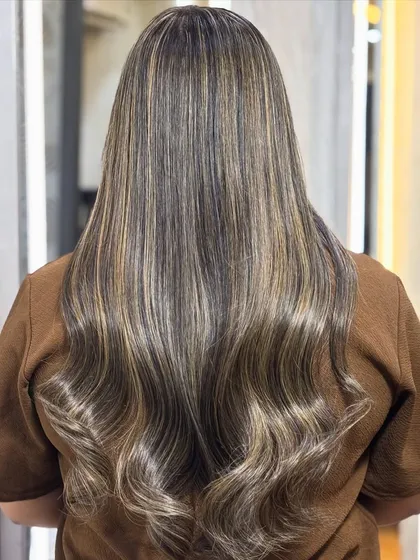 The back view of the creamy beige transformation shows the incredible lift and tone we achieved. The color is seamless and the hair looks healthy and full.