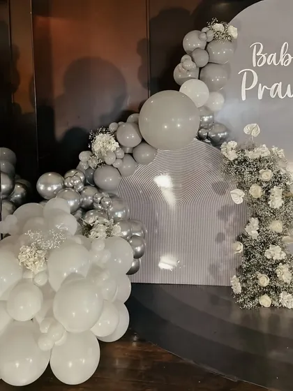 A detail shot of the custom "Baby Praun" backdrop, showing the clean lettering and the mix of matte and metallic balloons.