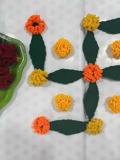 Creating a Swastik rangoli using my crochet marigold flowers and leaves. This is a simple way to make a beautiful and reusable festive decoration.