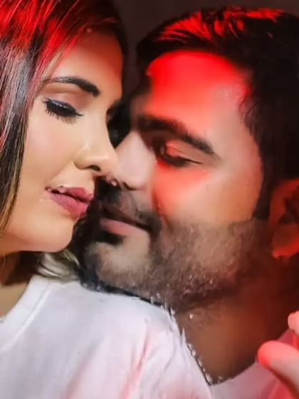 A sensual and intimate pre-wedding photo using a rain effect. This creative technique adds a layer of drama and romance, resulting in a very memorable and artistic shot.