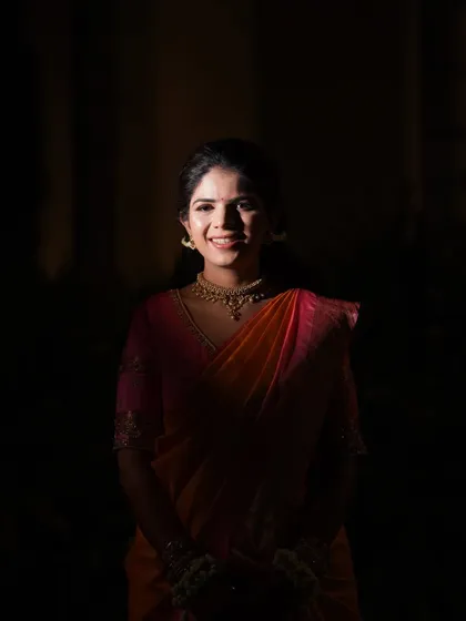 Another artistic low-key portrait of the bride. This style creates a timeless and elegant look, focusing solely on her happy expression.