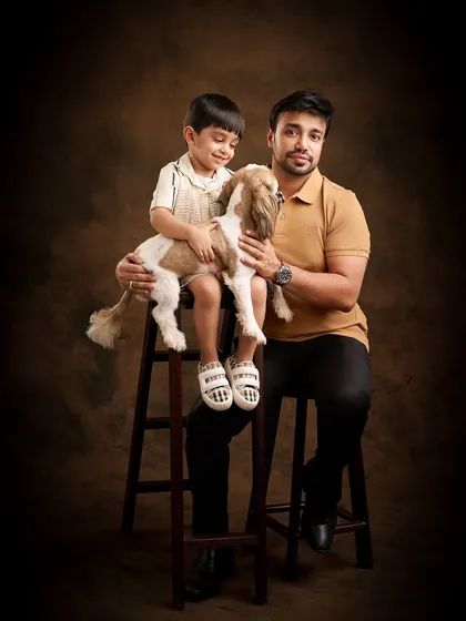 Pets are family, and we love including them in our sessions. This painterly portrait of a father, son, and their beloved dog against a classic brown backdrop creates a warm, classic image that feels like a treasured family painting.