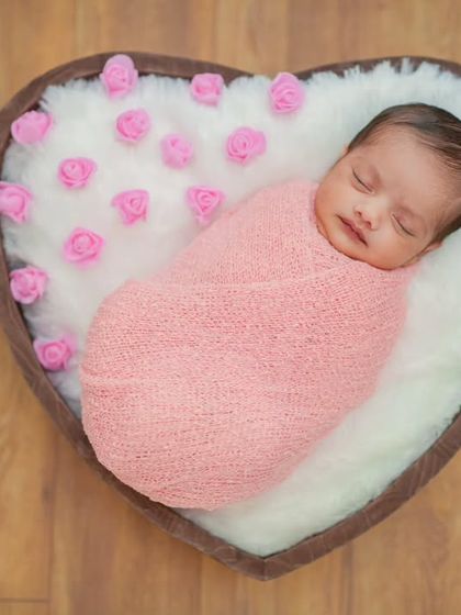 A perfectly centered top-down view of the sleeping newborn. This symmetrical composition is ideal for classic newborn announcements and albums.