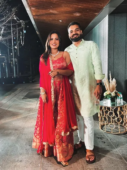 A different look for another wedding function. This red suit was a comfortable and elegant choice.