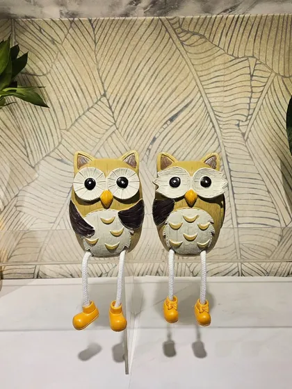 This pair of owls with dangling legs can sit on the edge of a shelf, adding a playful touch.