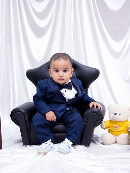 This little boss baby is celebrating his first birthday with his teddy bear and a special cake. We love creating these formal yet fun milestone portraits.