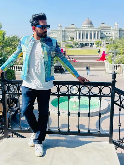 This patchwork-style jacket is perfect for when I have to land and perform right away. It's stylish, comfortable, and makes a statement against the grand backdrop of the Raffles hotel.