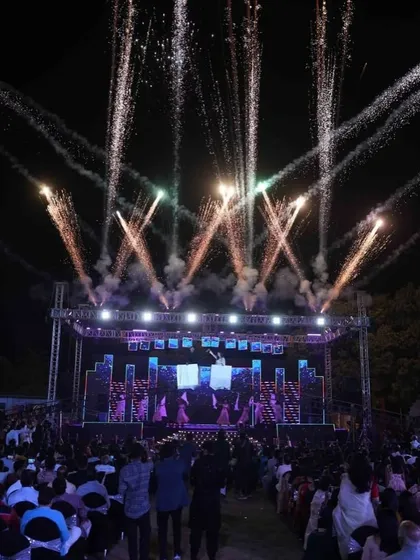 The view from the audience of a massive Sangeet production. The combination of a huge stage, lighting, and pyrotechnics creates an immersive concert-like experience for all the guests.