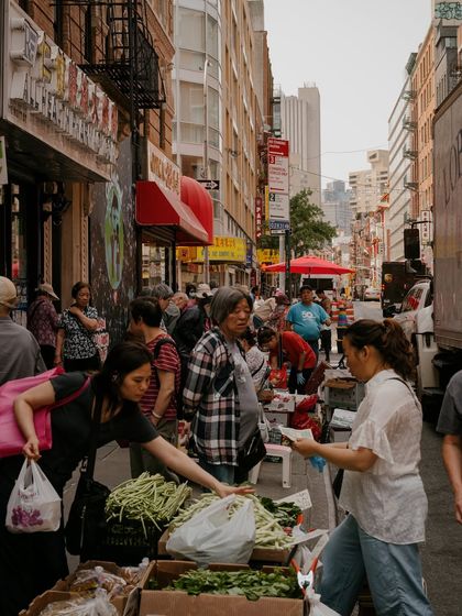 A busy street market in Chinatown. This candid shot captures the vibrant energy and daily life of the neighborhood.