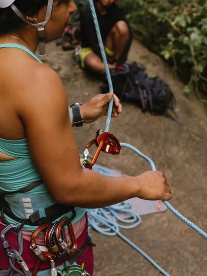 A climber practices her belay technique under the watchful eye of our instructors. Proper rope management is a skill we drill to ensure everyone's safety.