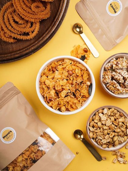 A colourful and delicious spread for your coffee break. This includes my popular Corn Mixture, sweet Peanut Chikki, savoury Hing Jeera Peanuts, and classic Garlic Murukku.