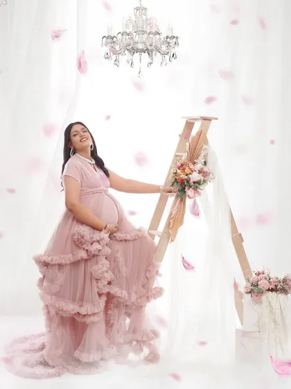 A full-on dreamy set for a glamorous maternity photoshoot. With a crystal chandelier, falling petals, and a stunning ruffled gown, we created a true fairytale moment.