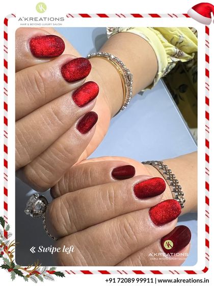 Both hands adorned with the sparkling red velvet manicure, accessorized with bracelets to complete the elegant holiday look.