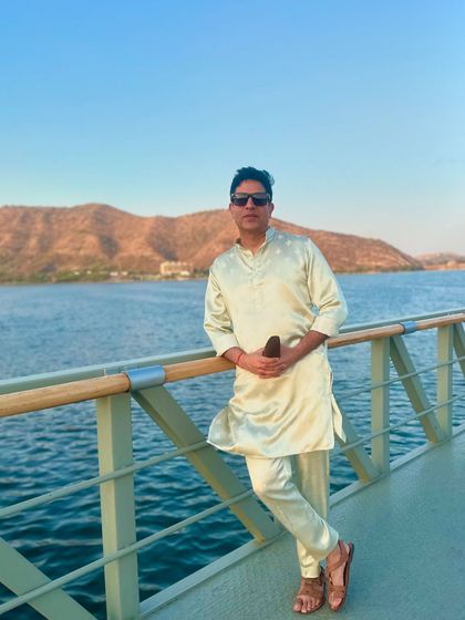 Leaning against a railing overlooking the water in Udaipur. The calm before the storm of a fantastic wedding party.