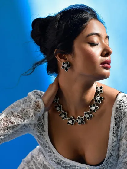A detailed profile view to give a clear look at the earring design and how it pairs with the necklace. Essential for e-commerce and lookbooks.
