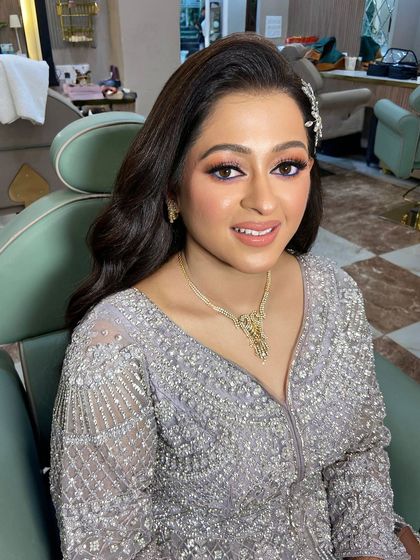 A lovely dewy look for this engagement bride. The soft purple eyeshadow adds a pop of color that complements her silver gown beautifully.