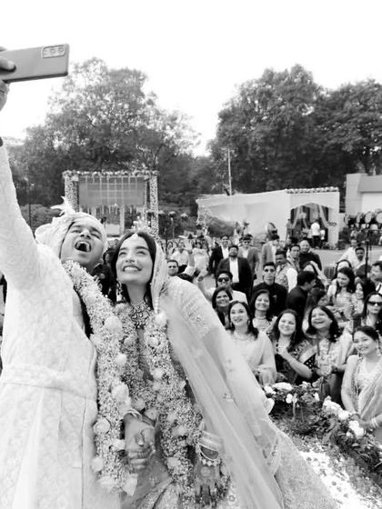 A modern tradition we love. Nidhi and Divya take a moment to capture their own selfie right after the ceremony, with all their cheering guests in the background. It's a fun, candid shot that perfectly encapsulates the joy of the day.