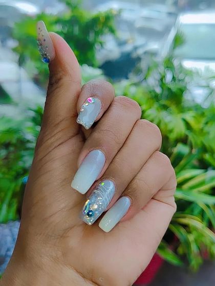 A soft and pretty design featuring a baby blue ombre effect with delicate glitter, line work, and a 3D floral accent.