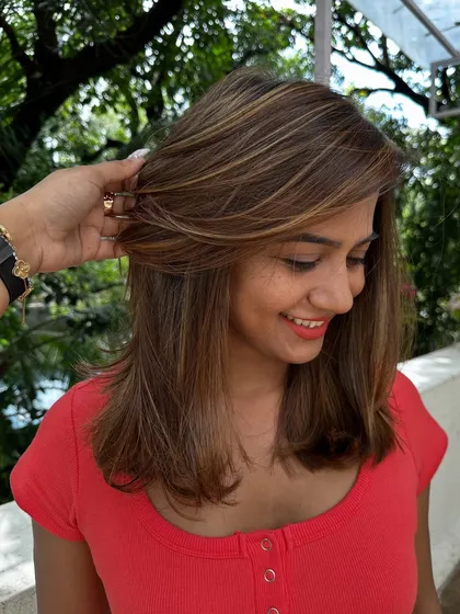 Be the life of every party with hair that shines. I gave her these bold, chunky highlights on a layered cut for a fun and glamorous look that’s sure to turn heads.