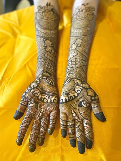 A full-arm bridal design featuring bands of marching elephants, a symbol of good luck and prosperity. The combination of fine lines and bold figures creates a rich texture.