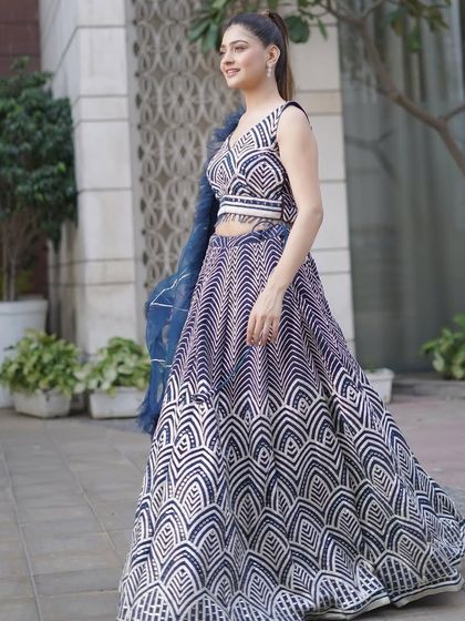Our model twirling in the navy and white geometric lehenga. The flowing skirt and modern print create a dynamic and eye-catching look.