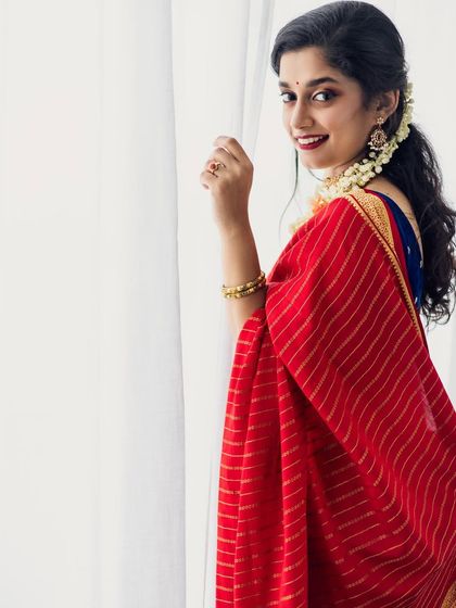 A candid, happy moment by the window. The natural light highlights the flawless finish of the makeup.