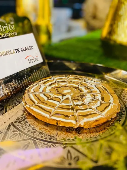 A classic milk chocolate waffle, beautifully presented on an ornate golden plate.