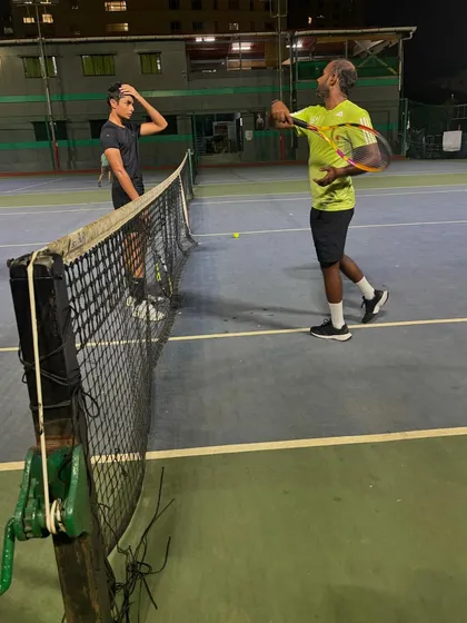 Demonstrating the correct racket path for a volley. We focus on teaching the finer points of the game to give our players an edge.