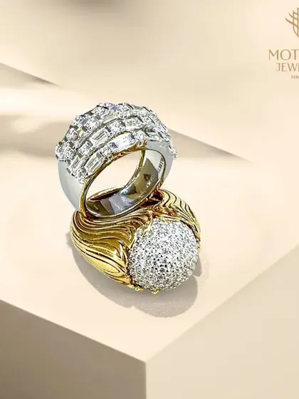 A study in contrasts. This set of two rings showcases different approaches to luxury, one with a dome of pave-set diamonds and the other with clean lines of baguette diamonds.