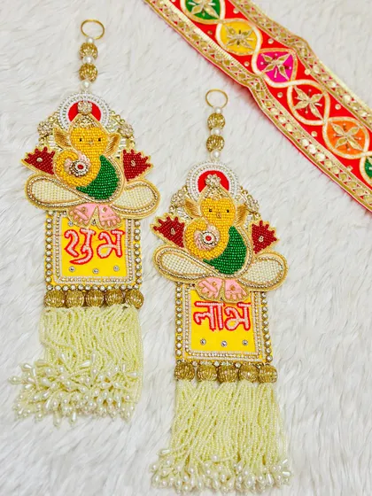 Welcome Lord Ganesha's blessings with this lovely latkan set. The design features a beaded Ganesha on a bright yellow background, perfect for new beginnings.