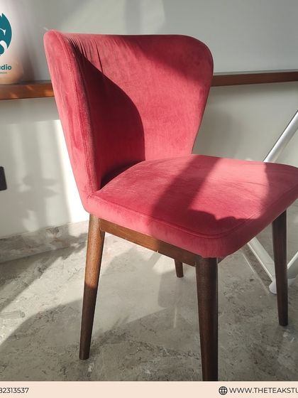 Another shot of the pink velvet dining chair, catching the sunlight to show off the rich texture of the fabric. It's a perfect accent chair or part of a vibrant dining set.