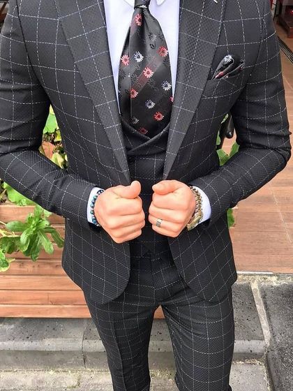 For a bolder look, I can craft suits with distinctive patterns like this charcoal grey suit with a windowpane check. The matching waistcoat and jacket create a cohesive and stylish outfit.